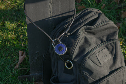 The Havlar backpack locked to a post with a blue padlock.