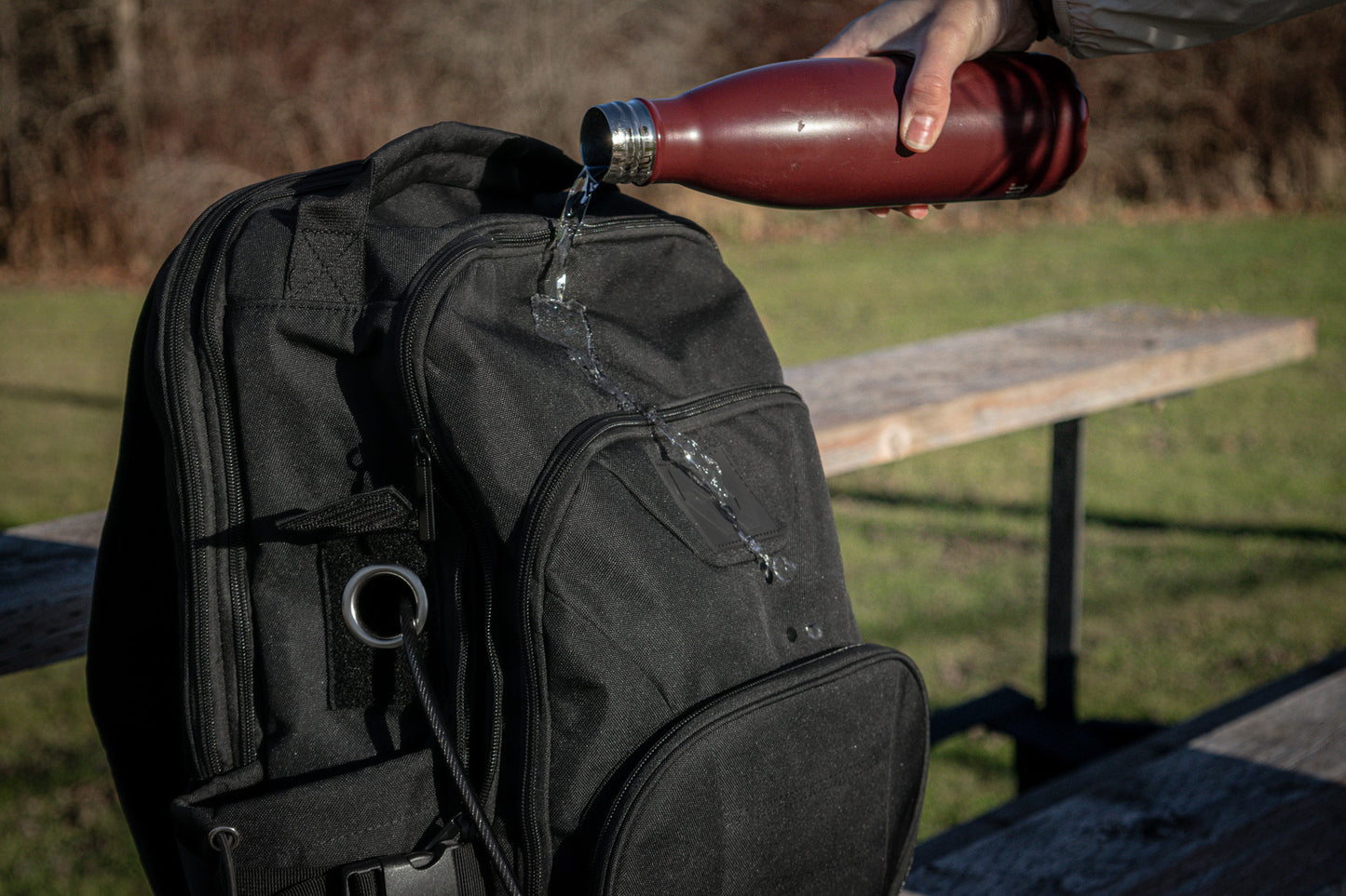 Water is poured on the Havlar backpack to display its water resistant capabilities.